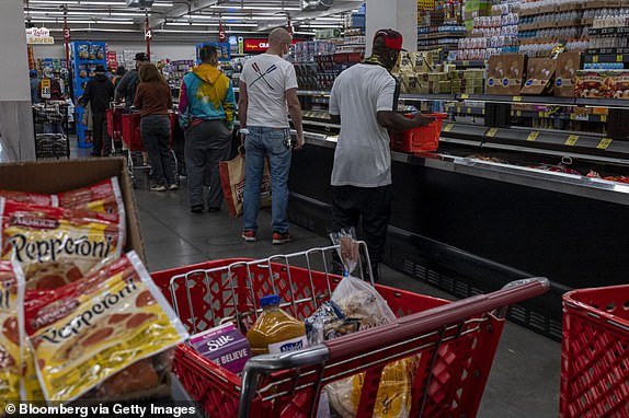 Customers wait in line to check out at a grocery store in San Francisco, California, U.S., Thursday, Nov. 11, 2021. U.S. consumer prices rose last month at the fastest annual pace since 1990, cementing high inflation as a hallmark of the pandemic recovery and eroding purchasing power even as wages rise. Photographer: David Paul Morris/Bloomberg via Getty Images